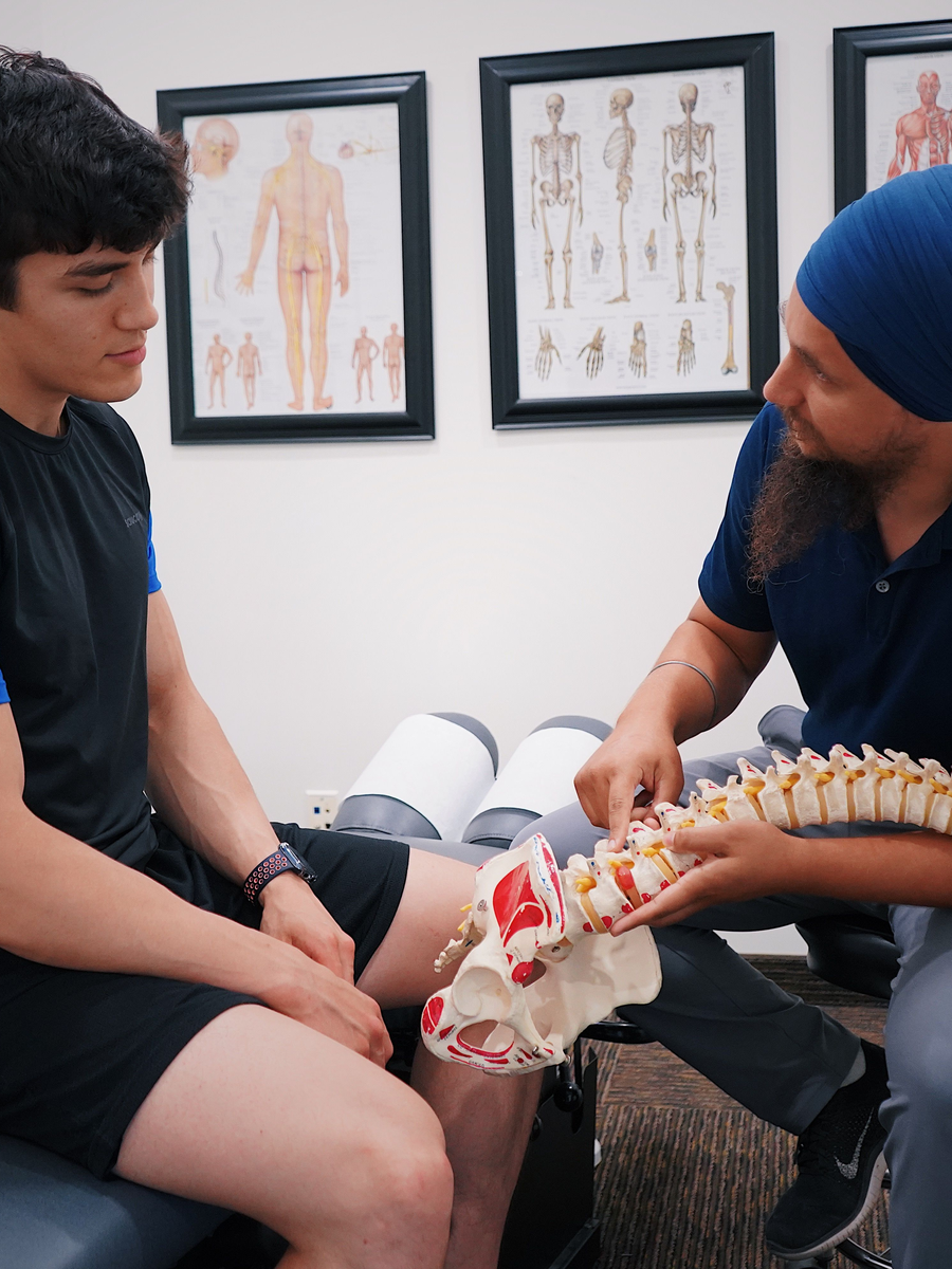 Healthcare professional explaining spine anatomy to a patient