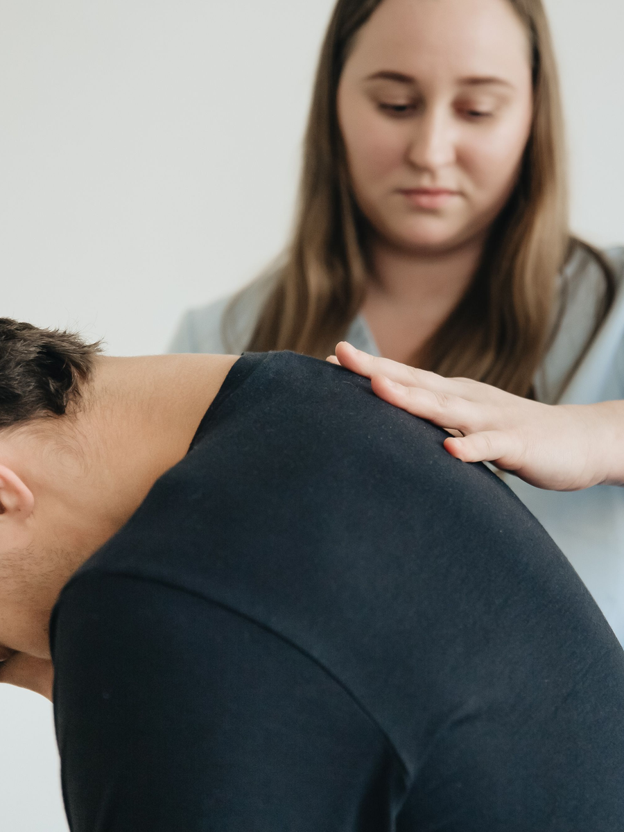 Healthcare professional assisting a patient during non-surgical back care